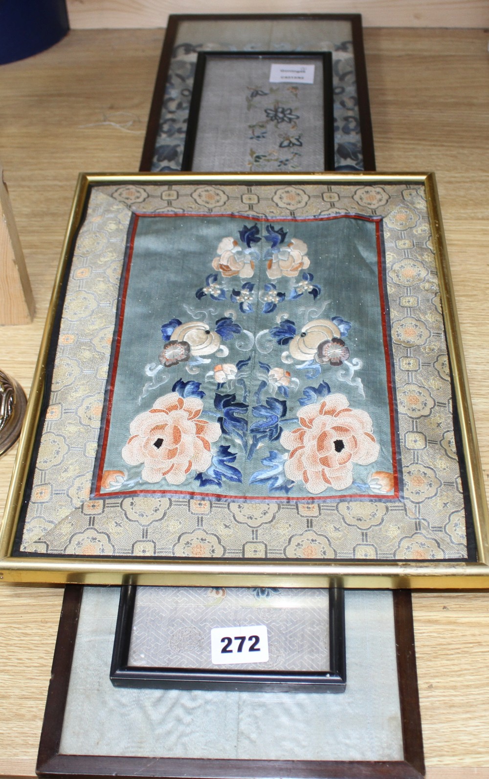 A Chinese silkwork double sleeve panel, 77 x 18cm overall, a smaller floral panel, 61 x 11cm and another, 34 x 26cm overall